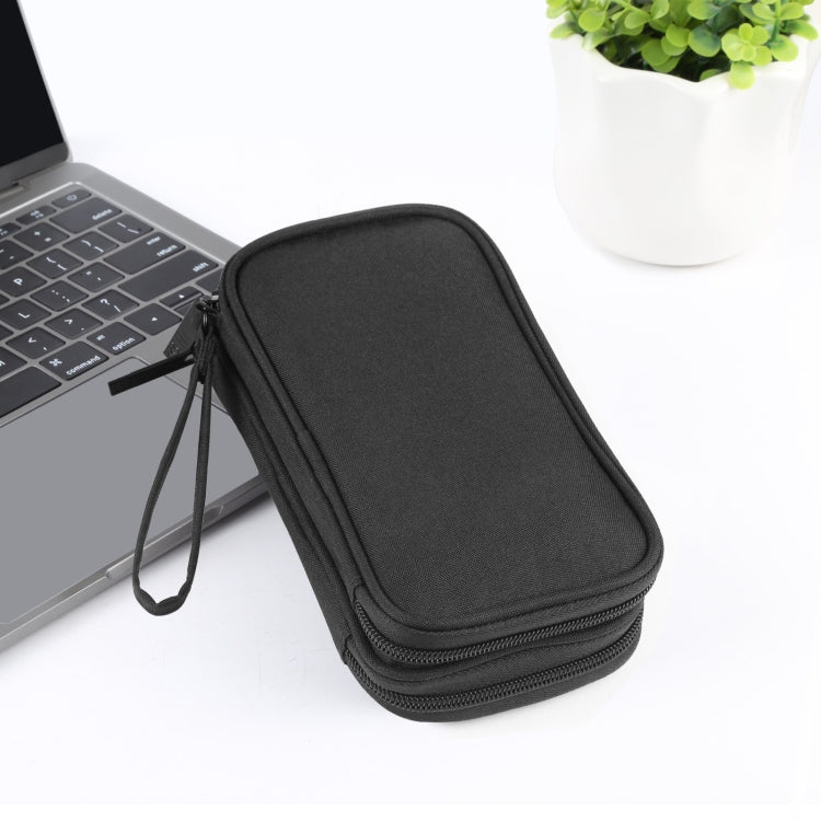 BTHG P01 black tech pouch closed next to a laptop