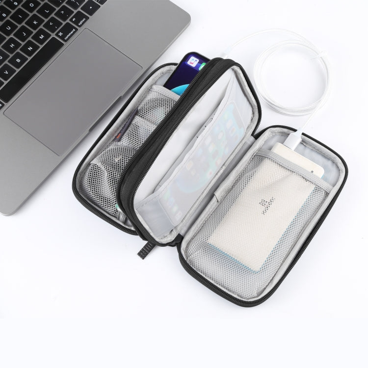 BTHG P01 black tech pouch open beside a laptop with accessories stored inside
